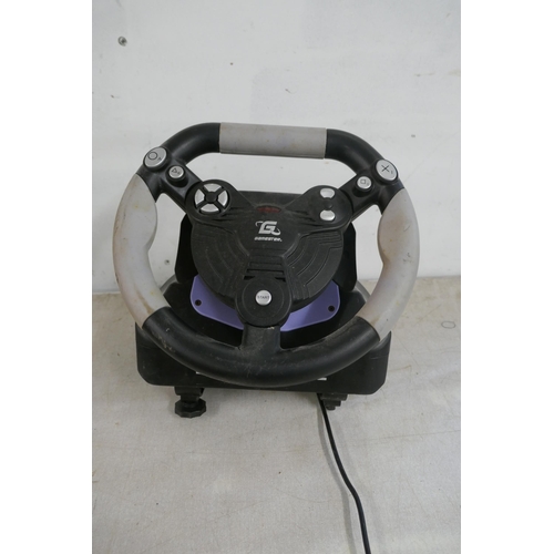 2357 - A quantity of video game steering wheels and pedals including a Snopy Mega Racing wheel and pedals, ... 