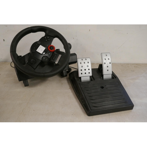 2357 - A quantity of video game steering wheels and pedals including a Snopy Mega Racing wheel and pedals, ... 