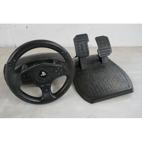 2357 - A quantity of video game steering wheels and pedals including a Snopy Mega Racing wheel and pedals, ... 