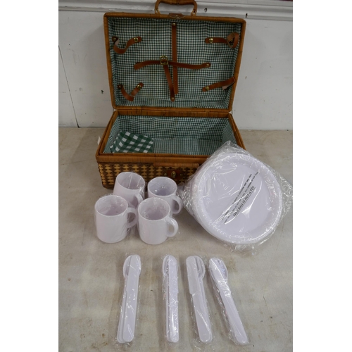 2365 - A wicker picnic hamper basket containing plastic plates, mugs and cutlery