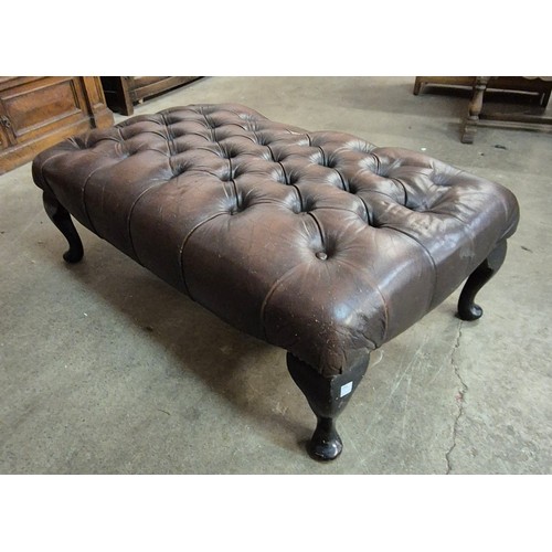 179A - A cheatnut brown leather Chesterfield footstool