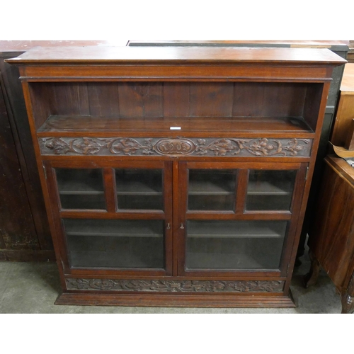 173 - A Victorian carved walnut two door bookcase