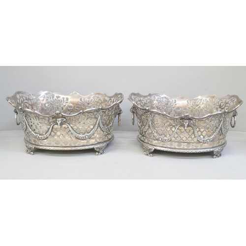 753 - A pair of Victorian pierced silver baskets with lion head ring handles and ram and swags details, ea... 