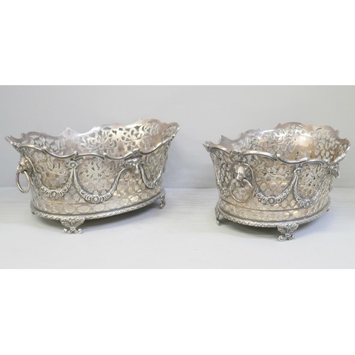 753 - A pair of Victorian pierced silver baskets with lion head ring handles and ram and swags details, ea... 