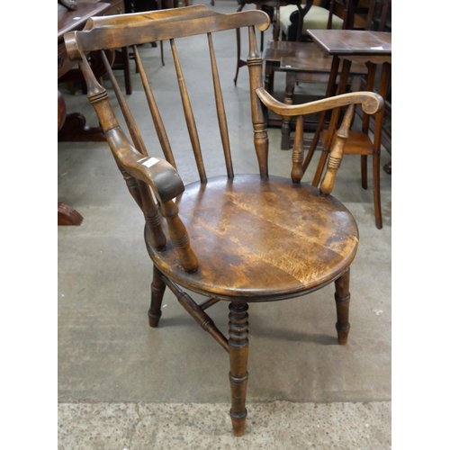 176 - A Victorian beech penny seat kitchen elbow chair