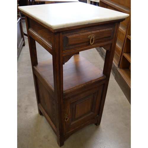 200 - A 19th Century French oak and marble topped table de nuit