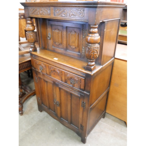 218 - An Elizabethan Revival carved oak dwarf sized court cupboard