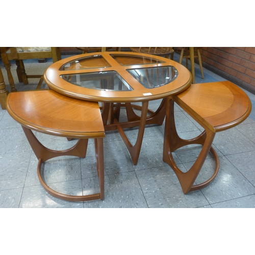 5 - A G-Plan teak and glass topped circular nest of tables