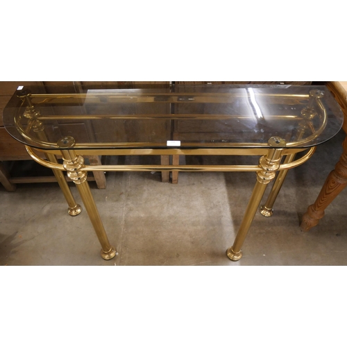 259 - An Italian style brass and glass topped console table