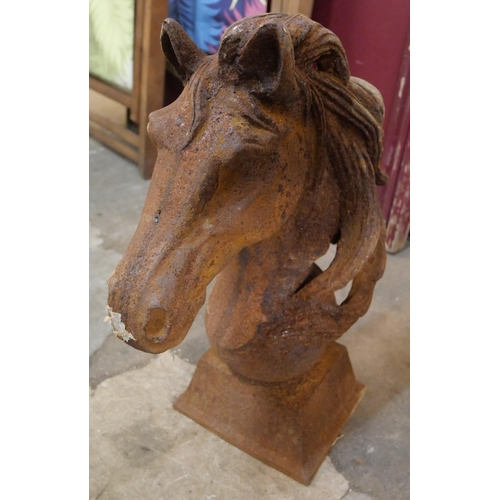 286 - A pair of cast iron horse's head garden ornaments