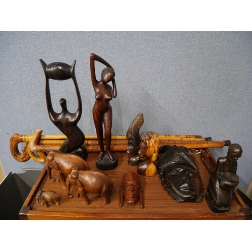 291 - Assorted carved wood figures and walking sticks