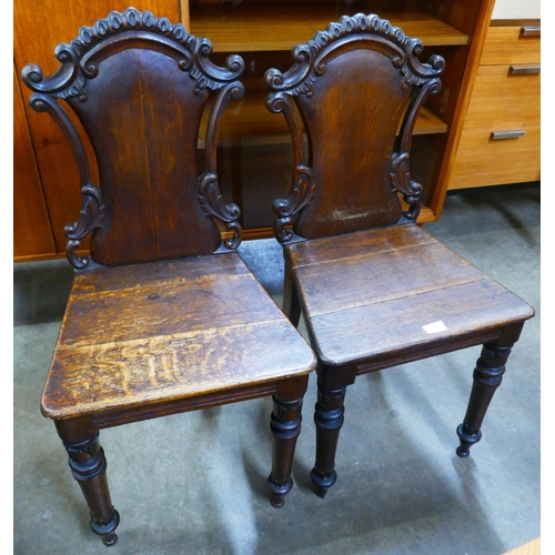 154 - A pair of Victorian carved oak hall chairs