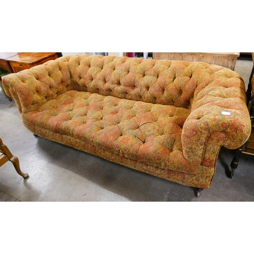 214 - A Victorian walnut and fabric upholstered Chesterfield settee