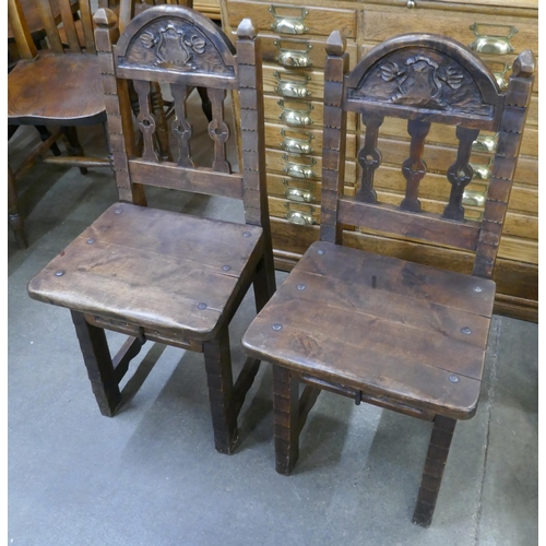 105 - A pair of French carved oak hall chairs