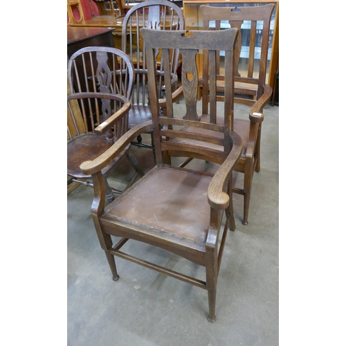 114 - A pair of Arts and Crafts oak elbow chairs