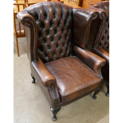 119 - A chestnut brown leather Chesterfield wingback armchair