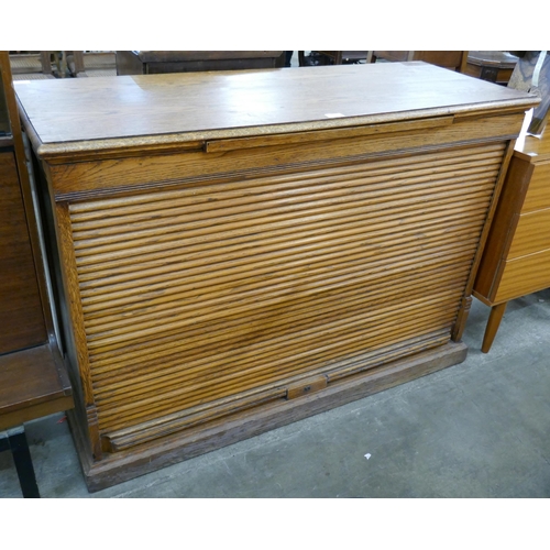 123 - An early 20th Century oak tambour front cabinet