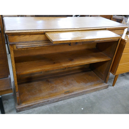 123 - An early 20th Century oak tambour front cabinet