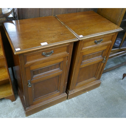 129 - A pair of Victorian walnut pot cupboards