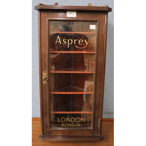 364 - A mahogany shop display cabinet, bearing later Asprey inscription to door