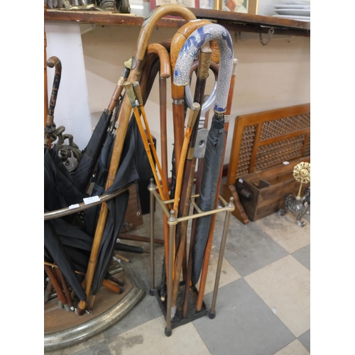 379 - Two metal stick stands and sticks