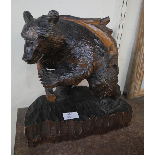 389 - An oriental carved softwood figure of a bear, 31cm high