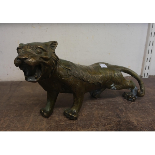 406 - An oriental bronze figure of a tiger