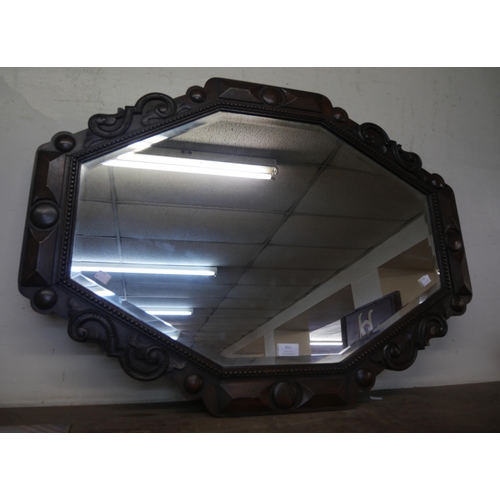 411 - An early 20th Century carved oak octagonal framed mirror