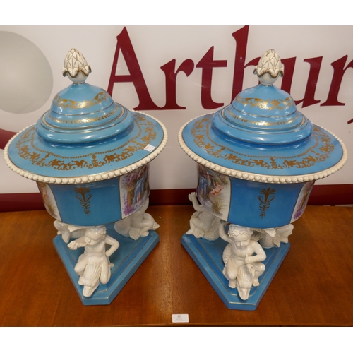 383A - A pair of large Sevres style powder blue porcelain vases and covers