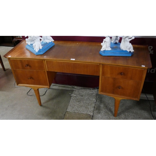 60 - A teak concave desk