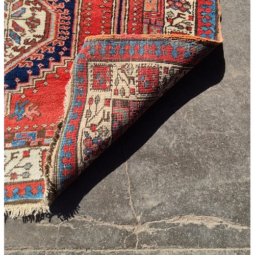 216D - An eastern terracotta ground runner rug, 300 x 115cms