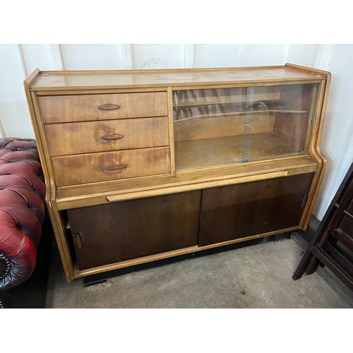 261 - A teak chest of drawers, dressing table, highboard and bookshelves