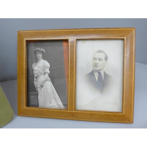 666 - An Edwardian dried flower display under a convex glass with silk photograph frame and a double leath... 