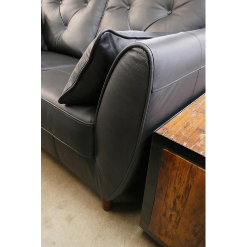 1325 - A black leather Hoxton two seater sofa and footstool RRP £2499