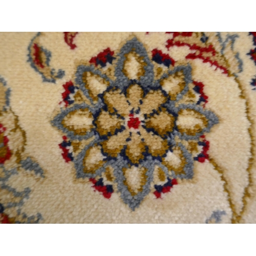 1343 - An ivory ground Cashmere carpet with all over floral pattern and gold border, 300 x 200