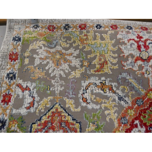 1353 - A grey ground contemporary carpet with all over multi coloured pattern, 330 x 240