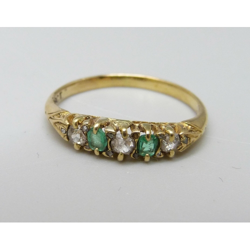 1022 - An 18ct gold, emerald and diamond seven stone ring, 2g, J