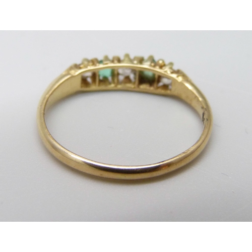 1022 - An 18ct gold, emerald and diamond seven stone ring, 2g, J