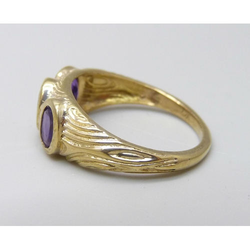 1027 - A silver gilt and amethyst trilogy ring, P