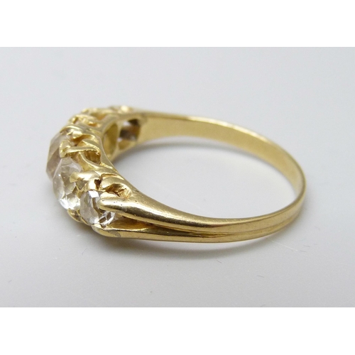 1042 - A yellow metal ring, (tests as 18ct gold), set with five old-cut diamonds on a double strand D-secti... 