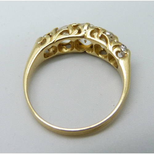 1042 - A yellow metal ring, (tests as 18ct gold), set with five old-cut diamonds on a double strand D-secti... 