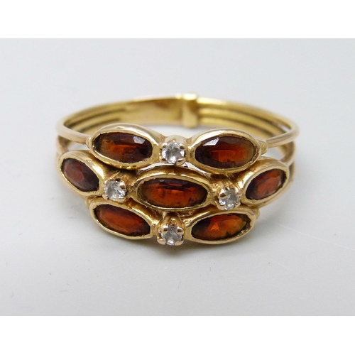 1043 - A yellow metal garnet and diamond cluster ring, 3.6g, T, continental control mark on the outside of ... 