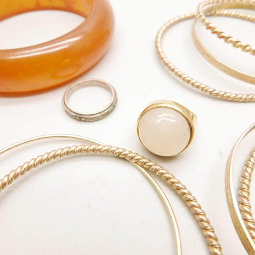 1071 - A collection of gold tone bangles and a ring, and one other bangle