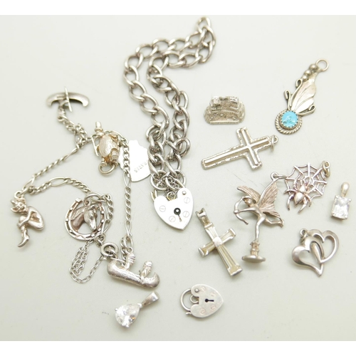 1085 - A silver charm bracelet, loose charms and a silver padlock bracelet, 42g