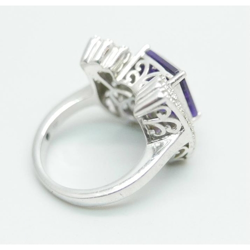 1094 - A silver ring with an amethyst and cubic zirconia set wing detail, size Q, by TJC