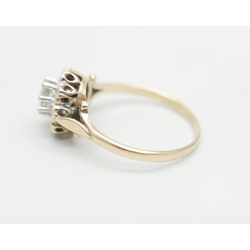 1099 - A 9ct gold ring set with a clear central stone and diamond chip halo, 2.2g, O