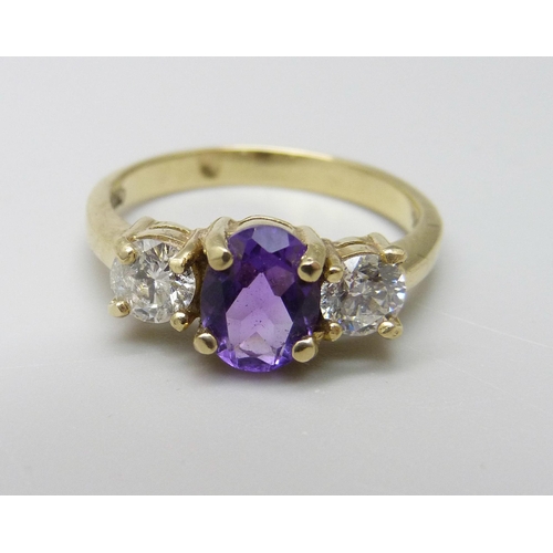 1019 - An 18ct gold, amethyst and diamond three stone ring, approximately 90ct weight, 3.9g, Q