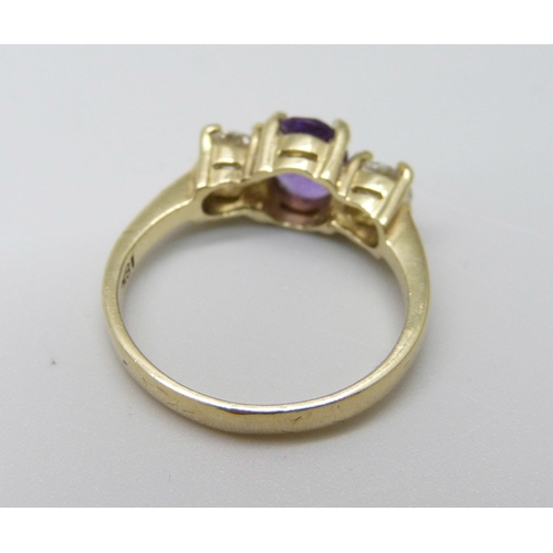 1019 - An 18ct gold, amethyst and diamond three stone ring, approximately 90ct weight, 3.9g, Q