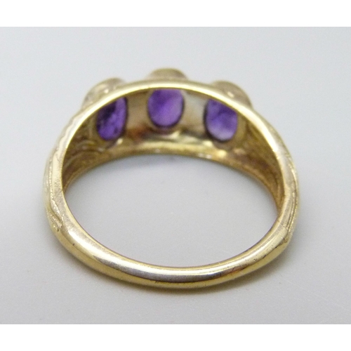 1027 - A silver gilt and amethyst trilogy ring, P