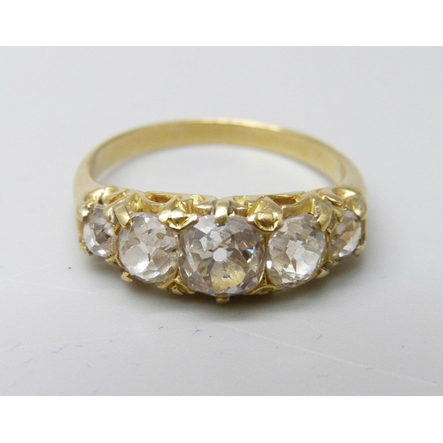 1042 - A yellow metal ring, (tests as 18ct gold), set with five old-cut diamonds on a double strand D-secti... 